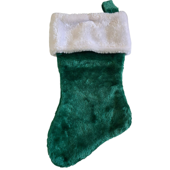 Green plush Christmas stocking with a white faux fur cuff on a white background